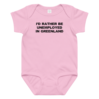 "I'd rather be unemployed in greenland" printed on a pink baby jersey bodysuit laying on a flat surface amongst other clothes