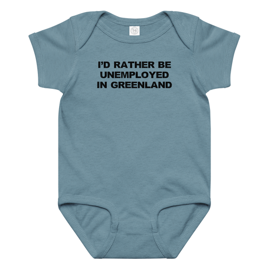 "I'd rather be unemployed in greenland" printed on a vintage indigo baby jersey bodysuit laying on a flat surface amongst other clothes