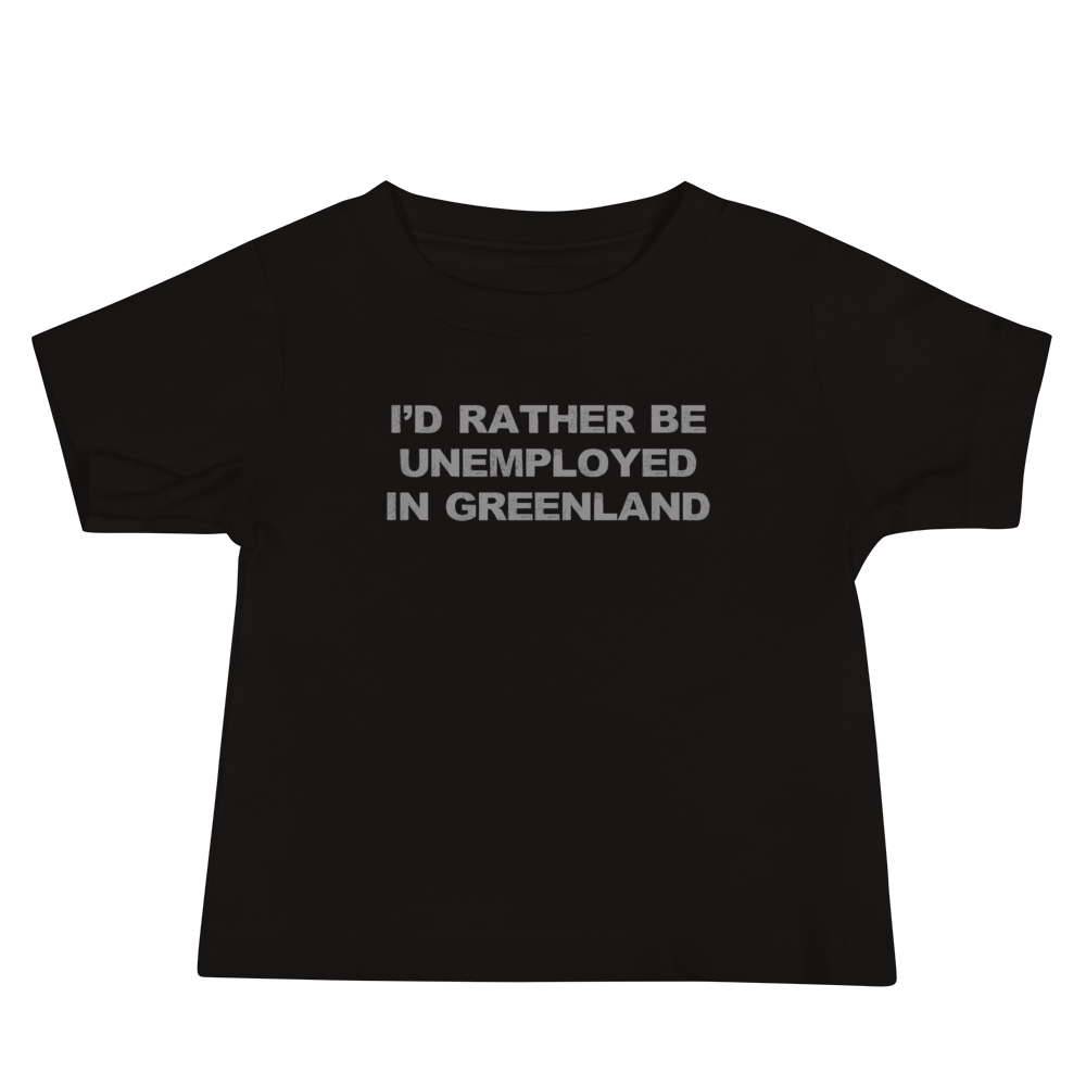 "I'd rather be unemployed in greenland" printed on a black baby jersey short sleeve tee laying on a flat surface