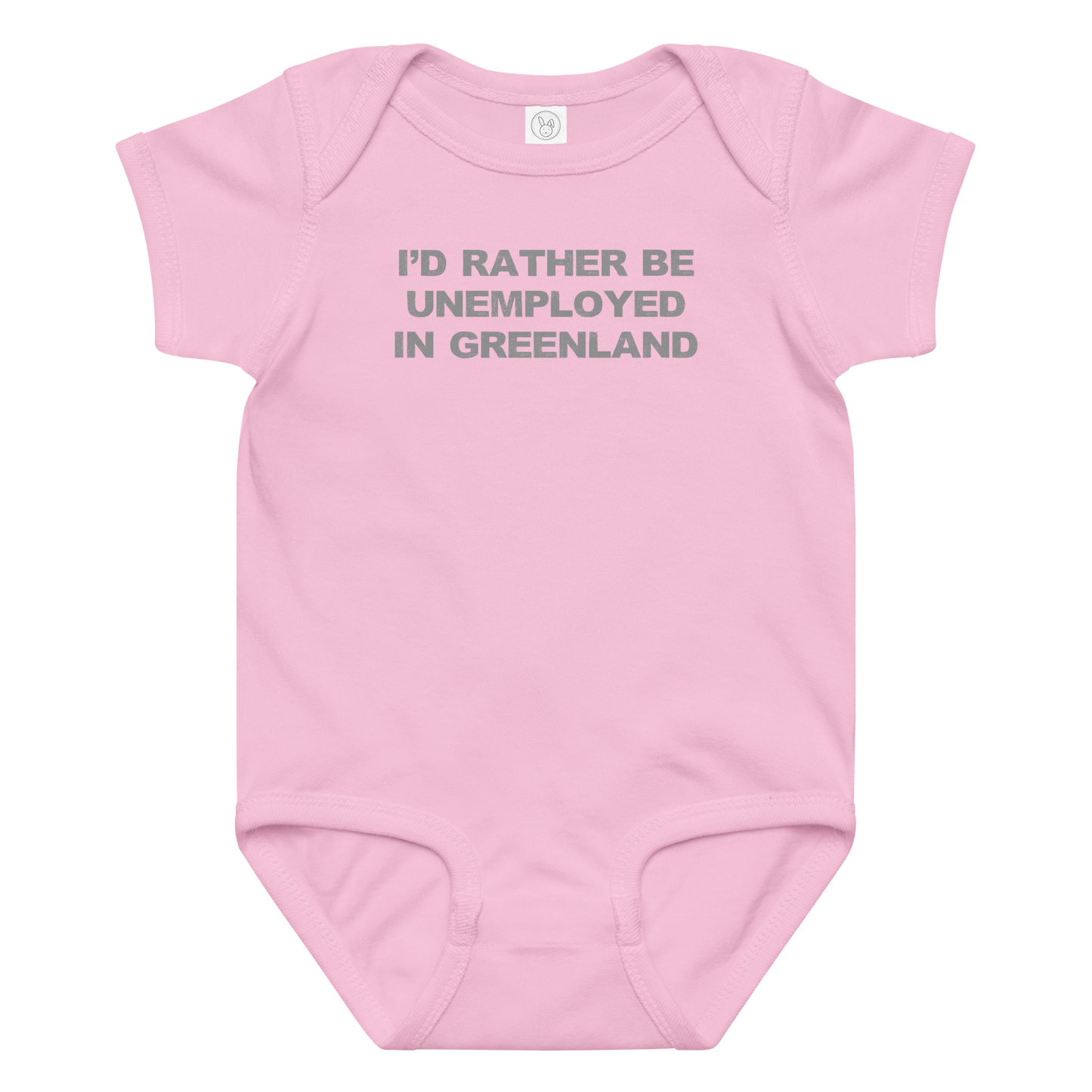 "I'd rather be unemployed in greenland" printed on a pink baby jersey bodysuit laying on a flat surface amongst other clothes