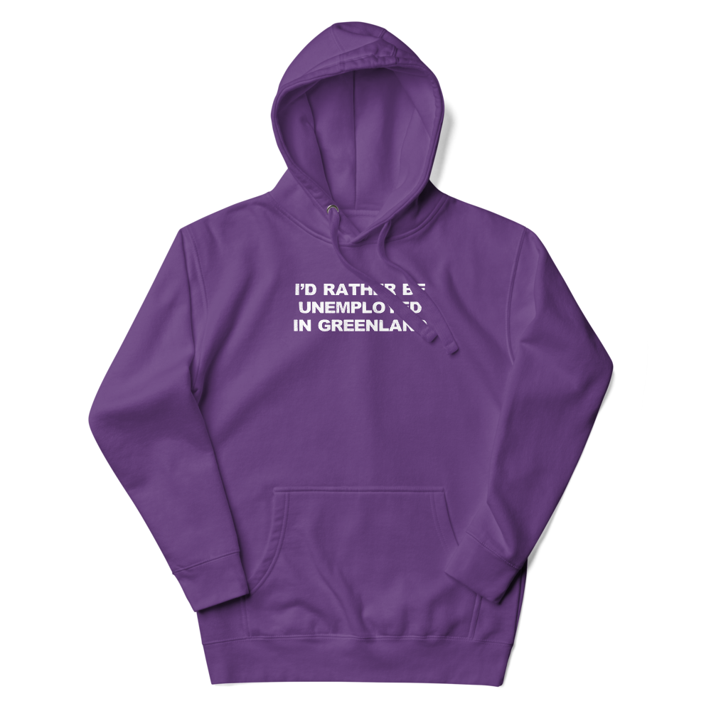 "I'd rather be unemployed in greenland" printed on a purple unisex hoodie laying on a flat surface with the hood up