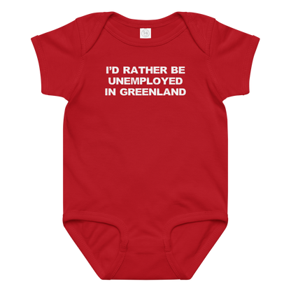 "I'd rather be unemployed in greenland" printed on a red baby jersey bodysuit laying on a flat surface amongst other clothes