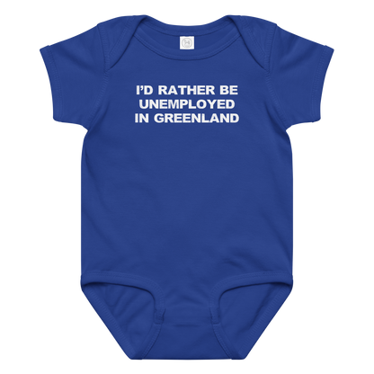 "I'd rather be unemployed in greenland" printed on a royal baby jersey bodysuit laying on a flat surface amongst other clothes