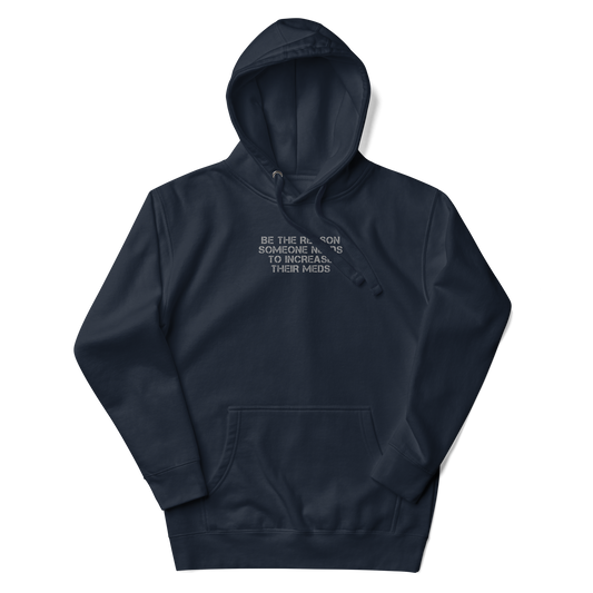 "Be the reason someone needs to increase their meds" printed on a navy blazer unisex hoodie laying on a flat surface with the hood up