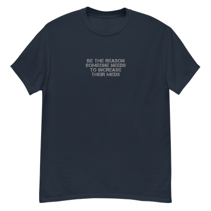 "Be the reason someone needs to increase their meds" printed on a navy unisex classic tee laying on a flat surface