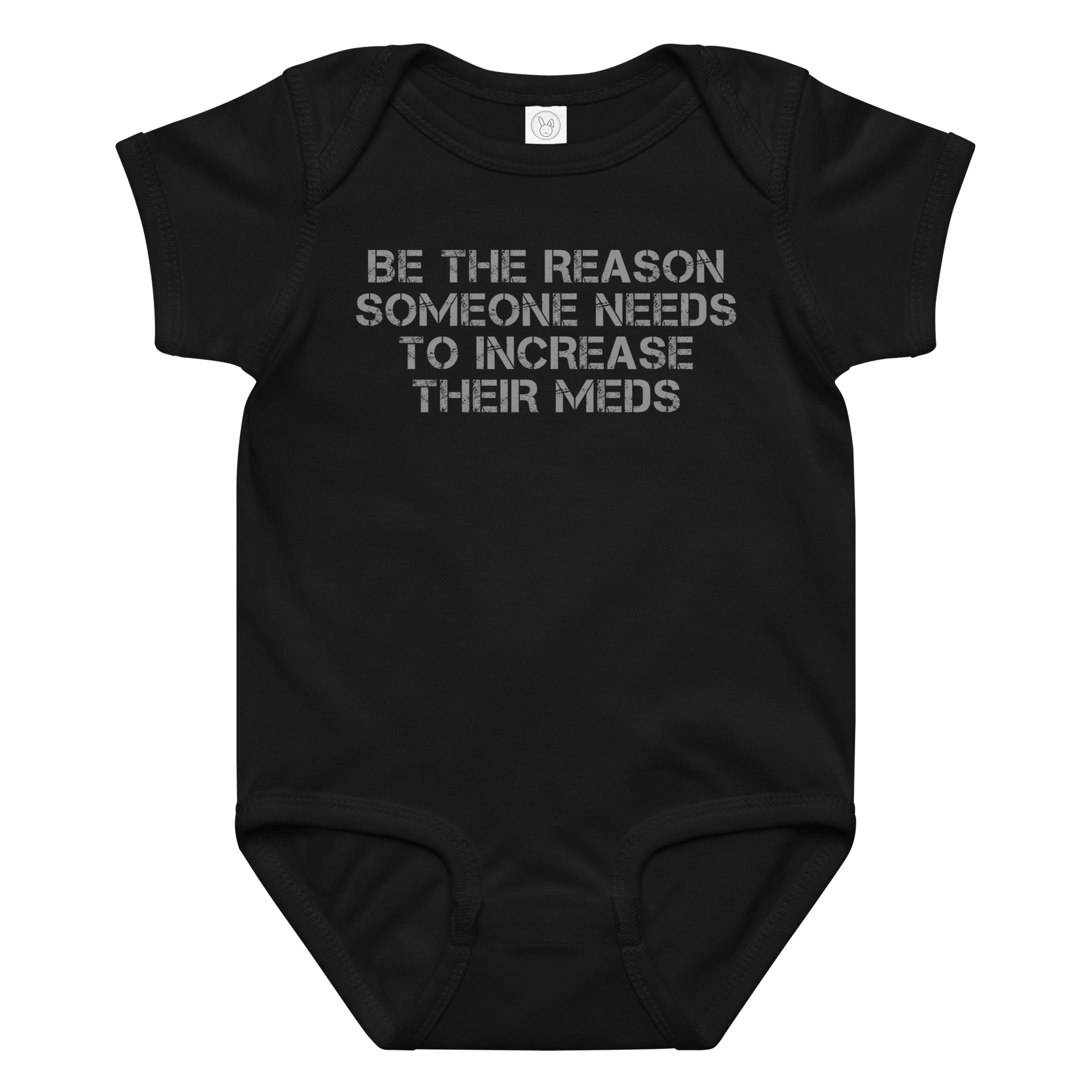 "Be the reason someone needs to increase their meds" printed on a black baby jersey bodysuit laying on a flat surface amongst other clothes