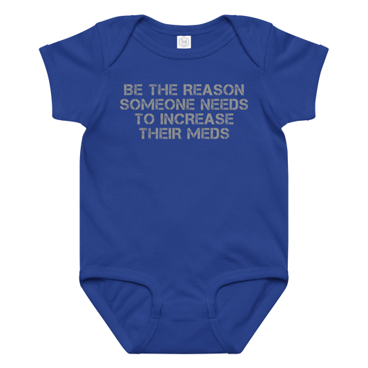"Be the reason someone needs to increase their meds" printed on a royal baby jersey bodysuit laying on a flat surface amongst other clothes