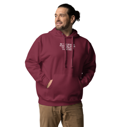 "Be the reason someone needs to increase their meds" printed on a maroon unisex hoodie worn by a male