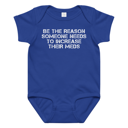 "Be the reason someone needs to increase their meds" printed on a royal baby jersey bodysuit laying on a flat surface amongst other clothes