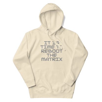 "It's time to reboot the matrix" printed on a bone unisex hoodie laying on a flat surface with the hood up