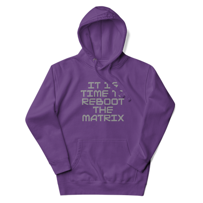 "It's time to reboot the matrix" printed on a purple unisex hoodie laying on a flat surface with the hood up