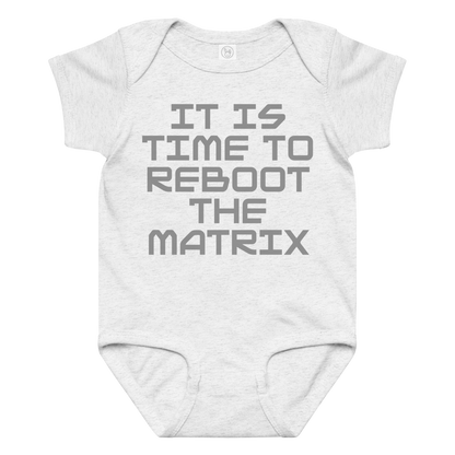 "It's time to reboot the matrix" printed on a ash baby jersey bodysuit laying on a flat surface amongst other clothes