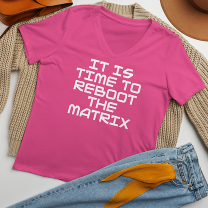 "It's time to reboot the matrix" printed on a berry women's relaxed v-neck t-shirt laying on a flat surface amongst other clothes