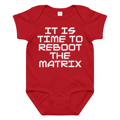 "It's time to reboot the matrix" printed on a red baby jersey bodysuit laying on a flat surface amongst other clothes
