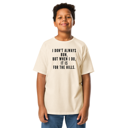 "I don't always run, but when I do, it is for the hills." printed on a natural youth classic tee worn by a male