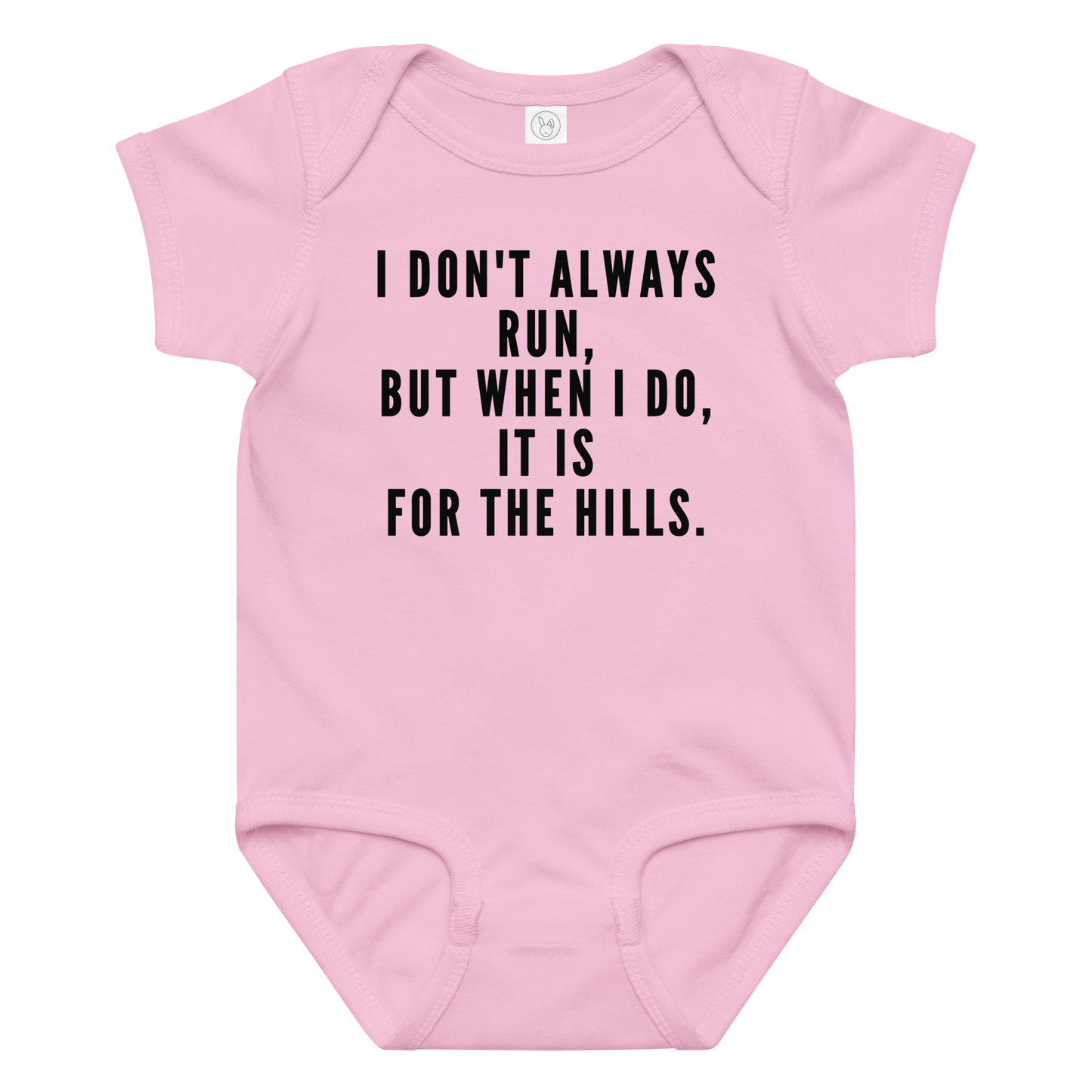 "I don't always run, but when I do, it is for the hills." printed on a pink baby jersey bodysuit laying on a flat surface amongst other clothes