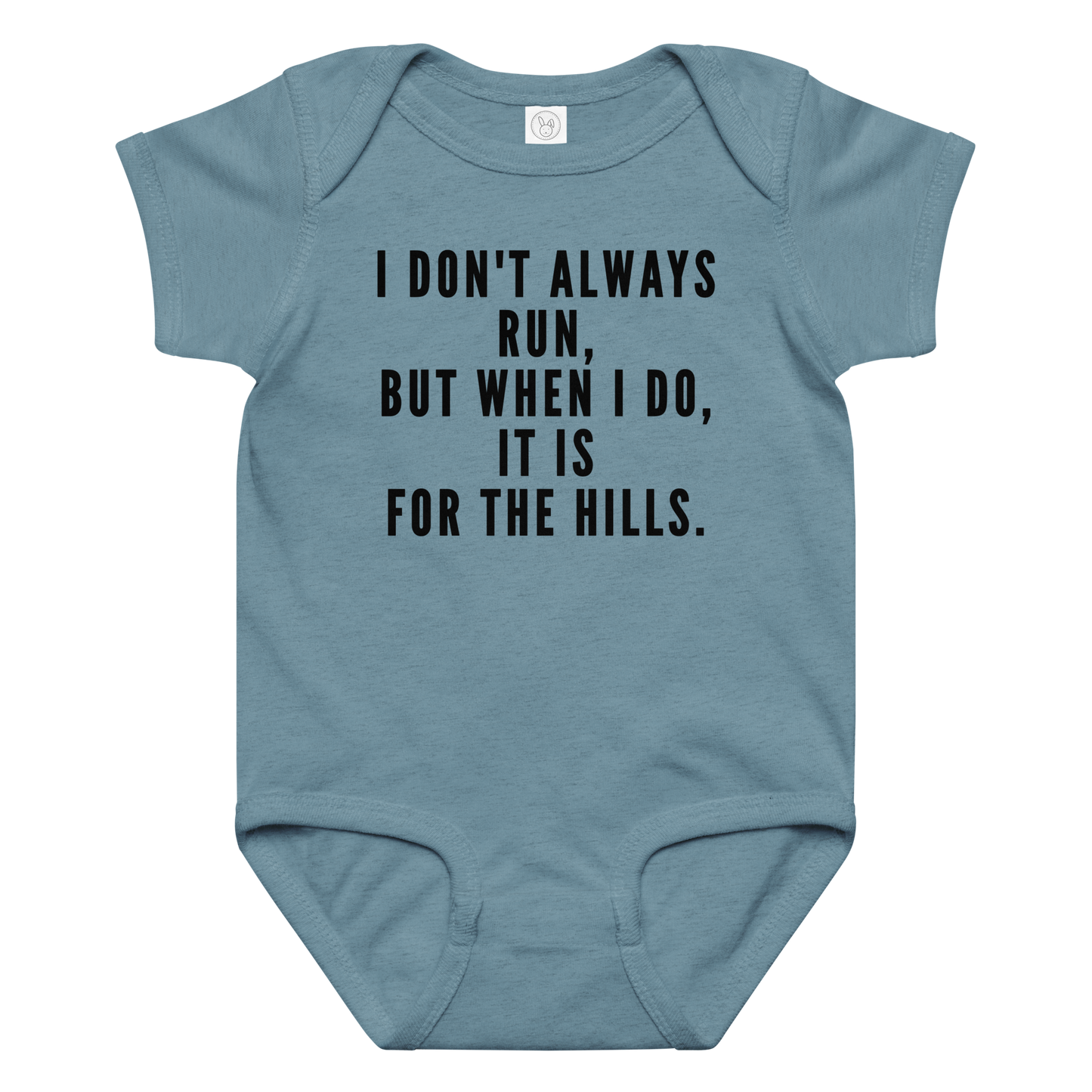 "I don't always run, but when I do, it is for the hills." printed on a vintage indigo baby jersey bodysuit laying on a flat surface amongst other clothes