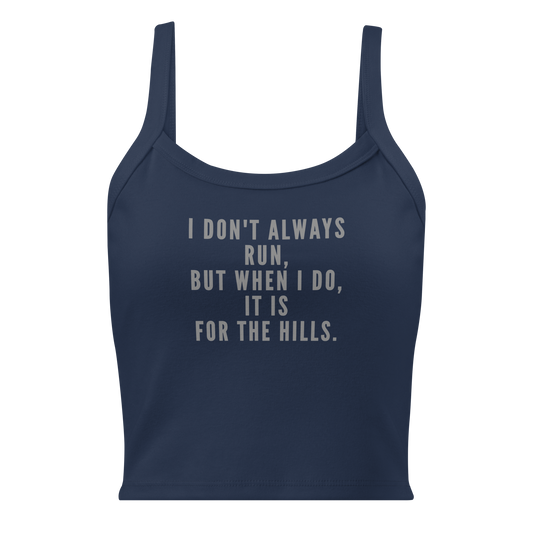 "I don't always run, but when I do, it is for the hills." printed on a solid navy blend women's micro-rib tanktop laying on a flat surface