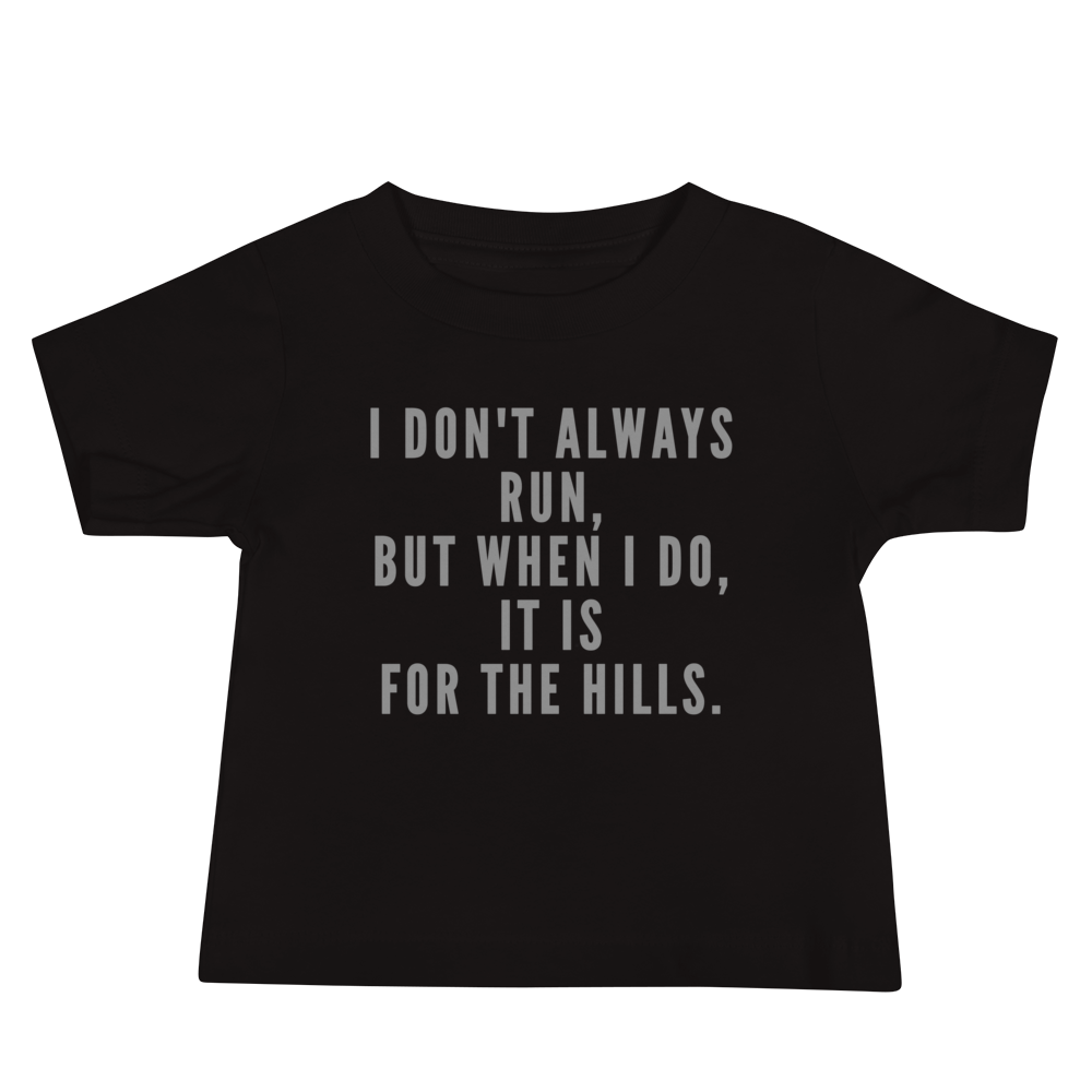 "I don't always run, but when I do, it is for the hills." printed on a black baby jersey short sleeve tee laying on a flat surface