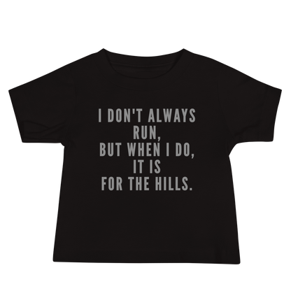 "I don't always run, but when I do, it is for the hills." printed on a black baby jersey short sleeve tee laying on a flat surface