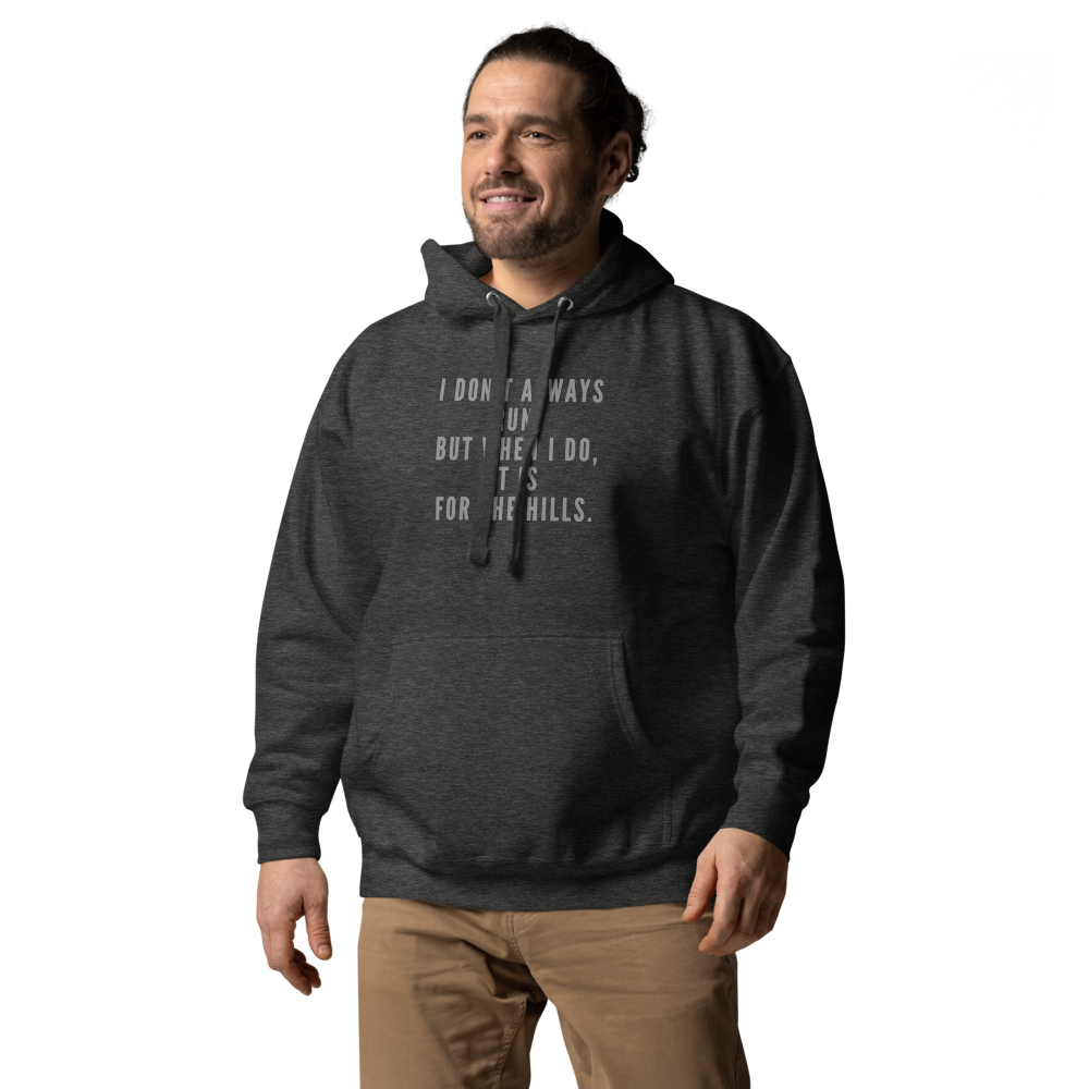 "I don't always run, but when I do, it is for the hills." printed on a charcoal heather unisex hoodie worn by a male