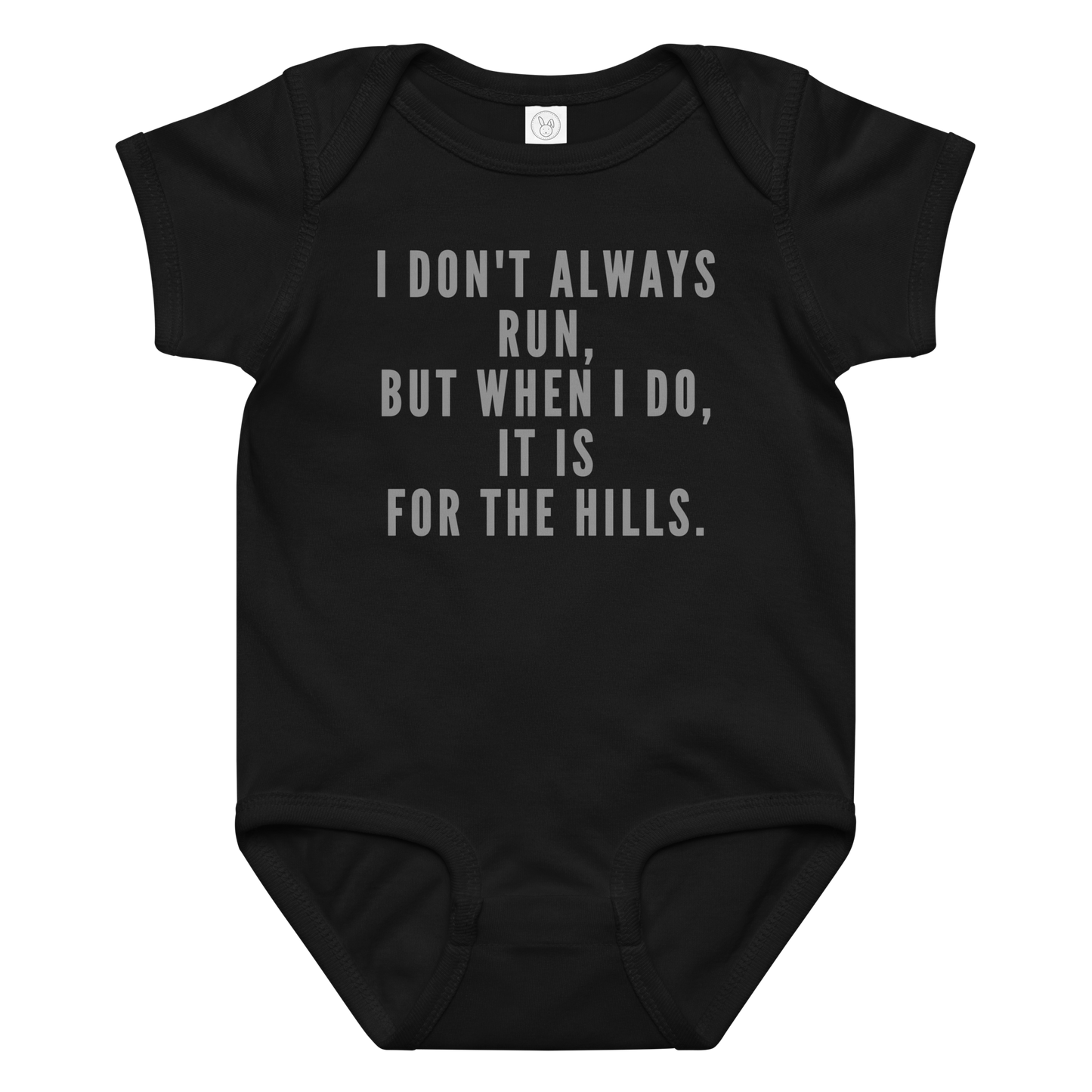 "I don't always run, but when I do, it is for the hills." printed on a black baby jersey bodysuit laying on a flat surface amongst other clothes