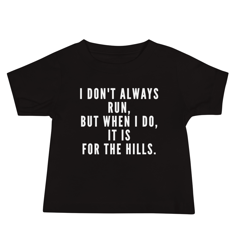 "I don't always run, but when I do, it is for the hills." printed on a black baby jersey short sleeve tee laying on a flat surface
