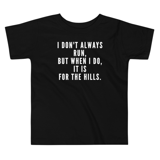 "I don't always run, but when I do, it is for the hills." printed on a black toddler short sleeve tee laying on a flat surface