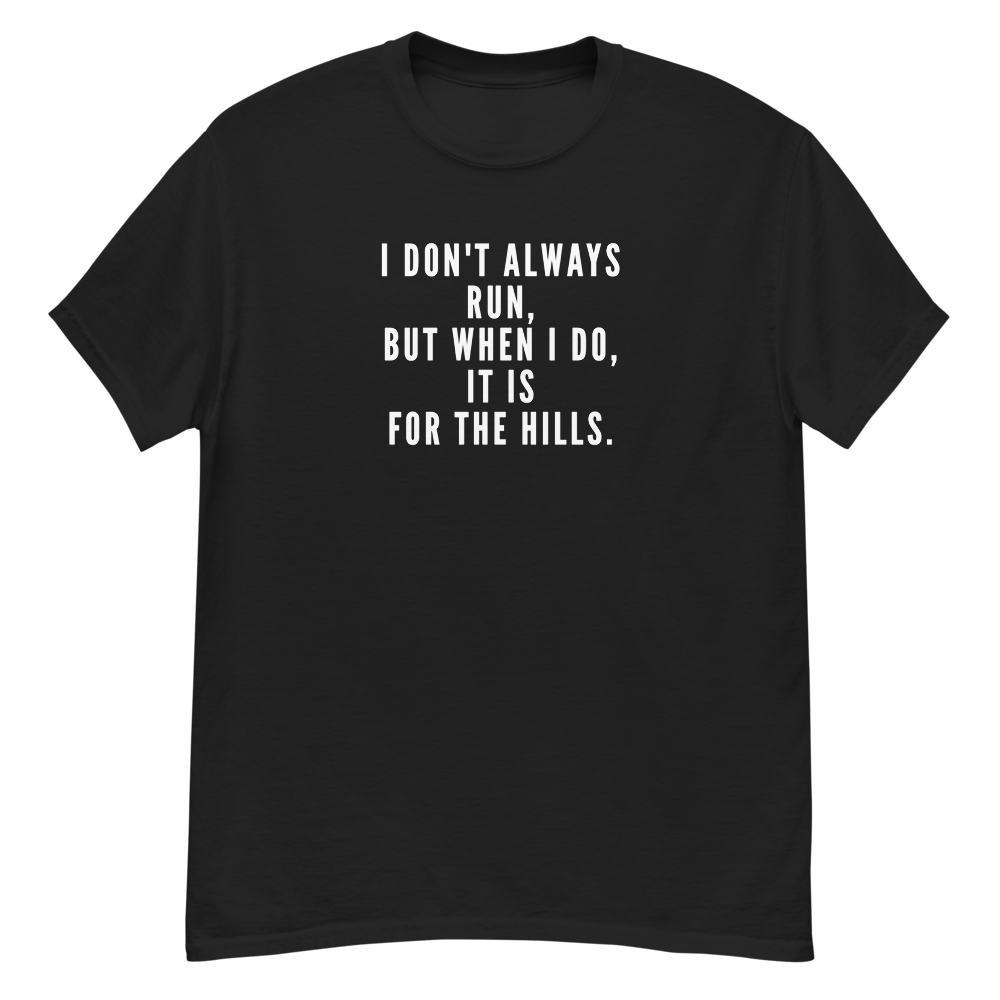 "I don't always run, but when I do, it is for the hills." printed on a black unisex classic tee laying on a flat surface