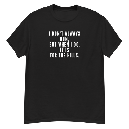 "I don't always run, but when I do, it is for the hills." printed on a black unisex classic tee laying on a flat surface