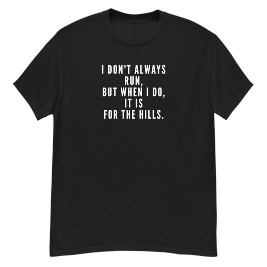 "I don't always run, but when I do, it is for the hills." printed on a black unisex classic tee laying on a flat surface