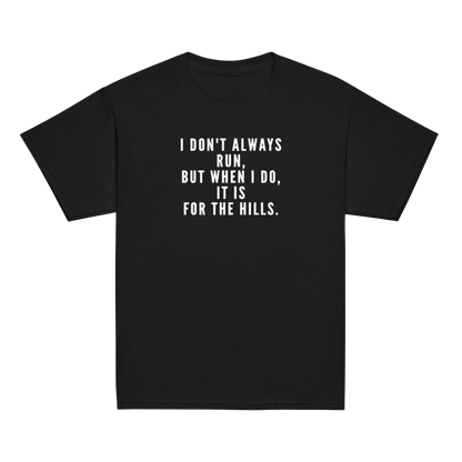 "I don't always run, but when I do, it is for the hills." printed on a black youth classic tee laying on a flat surface