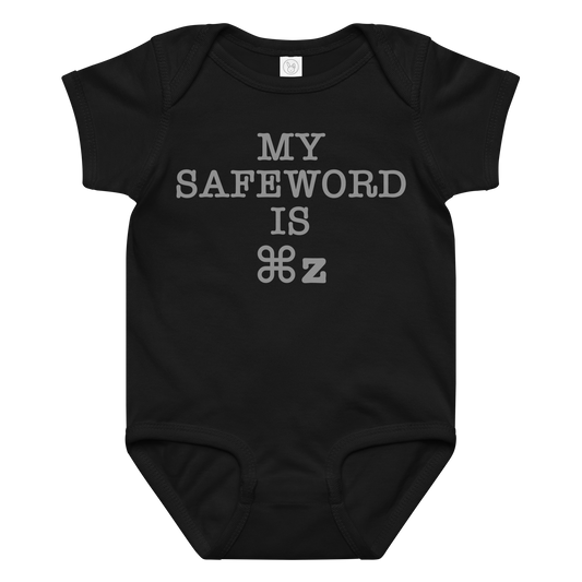 "My Safe Word Is ⌘Z" printed on a black baby jersey bodysuit laying on a flat surface amongst other clothes