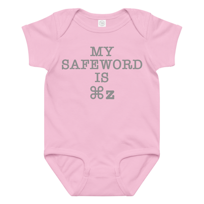 "My Safe Word Is ⌘Z" printed on a pink baby jersey bodysuit laying on a flat surface amongst other clothes
