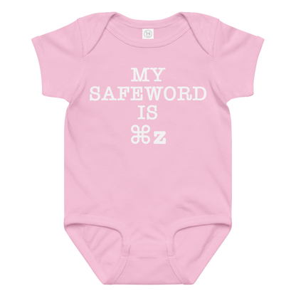 "My Safe Word Is ⌘Z" printed on a pink baby jersey bodysuit laying on a flat surface amongst other clothes