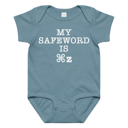 "My Safe Word Is ⌘Z" printed on a vintage indigo baby jersey bodysuit laying on a flat surface amongst other clothes