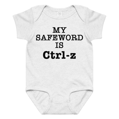 "My Safe Word Is Ctrl-Z" printed on a ash baby jersey bodysuit laying on a flat surface amongst other clothes