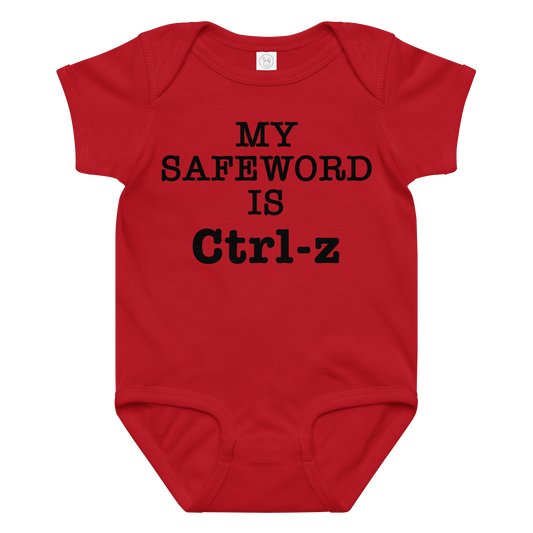 "My Safe Word Is Ctrl-Z" printed on a red baby jersey bodysuit laying on a flat surface amongst other clothes