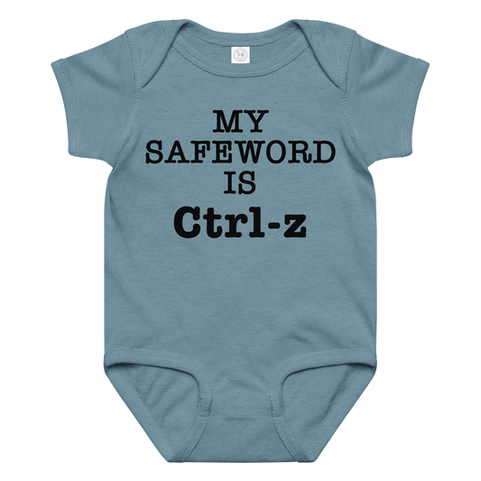 "My Safe Word Is Ctrl-Z" printed on a vintage indigo baby jersey bodysuit laying on a flat surface amongst other clothes