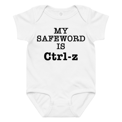 "My Safe Word Is Ctrl-Z" printed on a white baby jersey bodysuit laying on a flat surface amongst other clothes