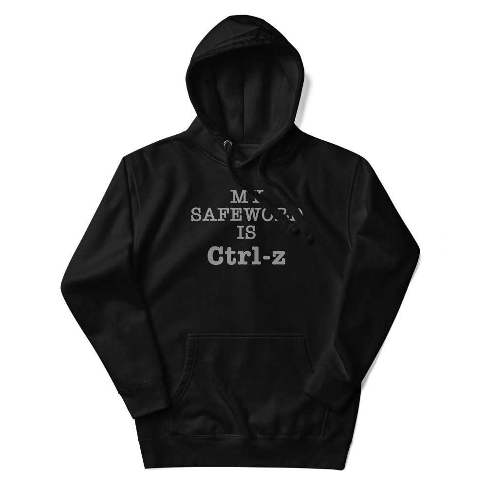 "My Safe Word Is Ctrl-Z" printed on a black unisex hoodie laying on a flat surface with the hood up