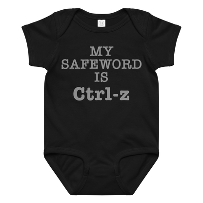"My Safe Word Is Ctrl-Z" printed on a black baby jersey bodysuit laying on a flat surface amongst other clothes