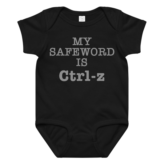 "My Safe Word Is Ctrl-Z" printed on a black baby jersey bodysuit laying on a flat surface amongst other clothes