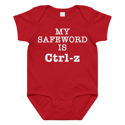 "My Safe Word Is Ctrl-Z" printed on a red baby jersey bodysuit laying on a flat surface amongst other clothes
