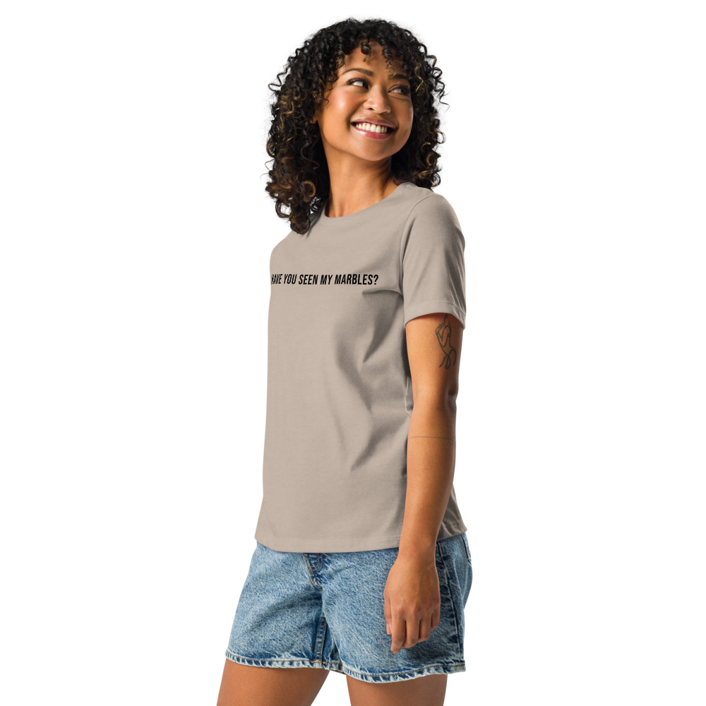 "Have you seen my marbles?" printed on a heather stone women's relaxed t-shirt worn by a female