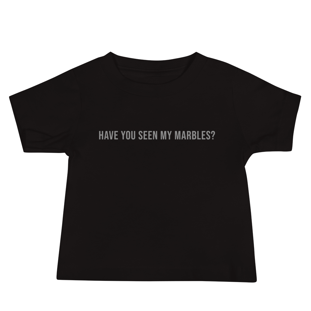 "Have you seen my marbles?" printed on a black baby jersey short sleeve tee laying on a flat surface
