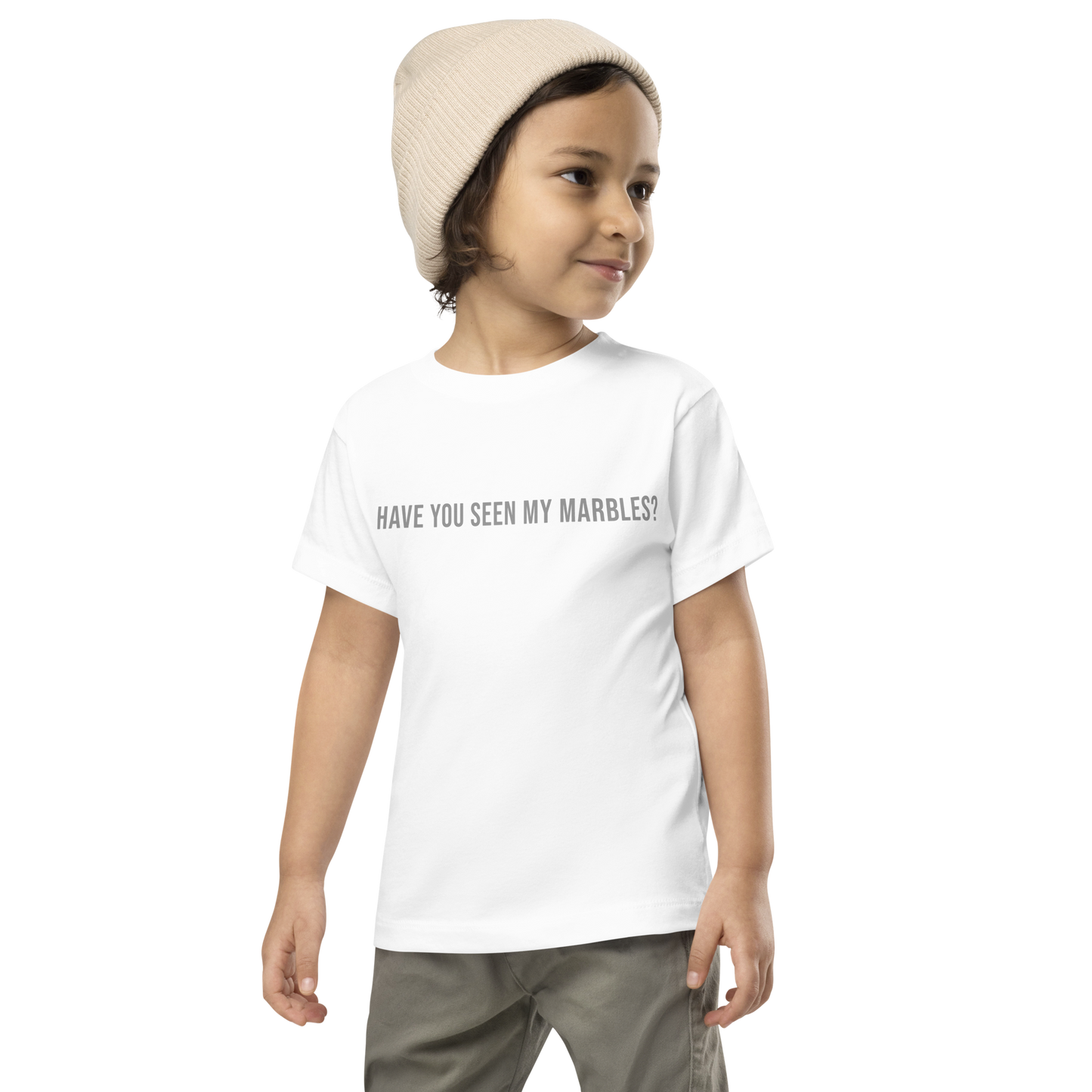 "Have you seen my marbles?" printed on a white toddler short sleeve tee worn by a male wearing a cap