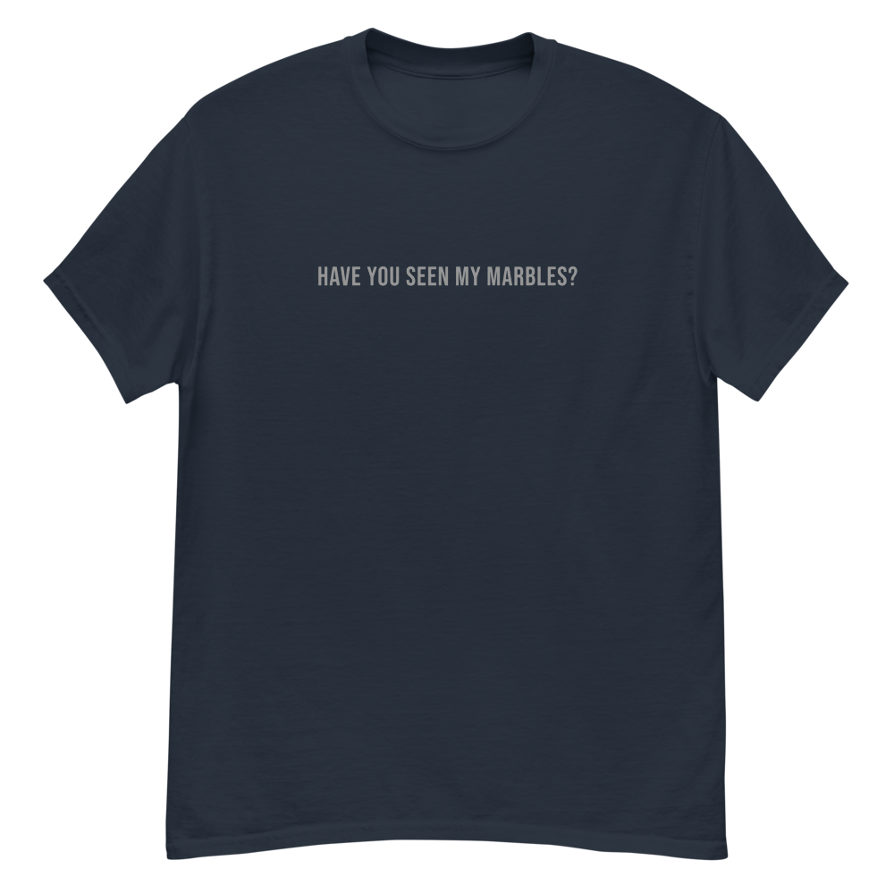 "Have you seen my marbles?" printed on a navy unisex classic tee laying on a flat surface