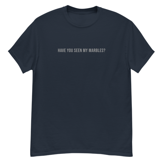 "Have you seen my marbles?" printed on a navy unisex classic tee laying on a flat surface