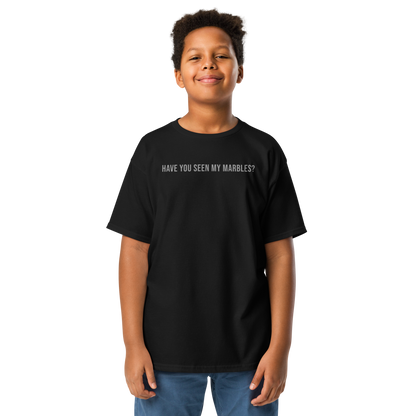 "Have you seen my marbles?" printed on a black youth classic tee worn by a male